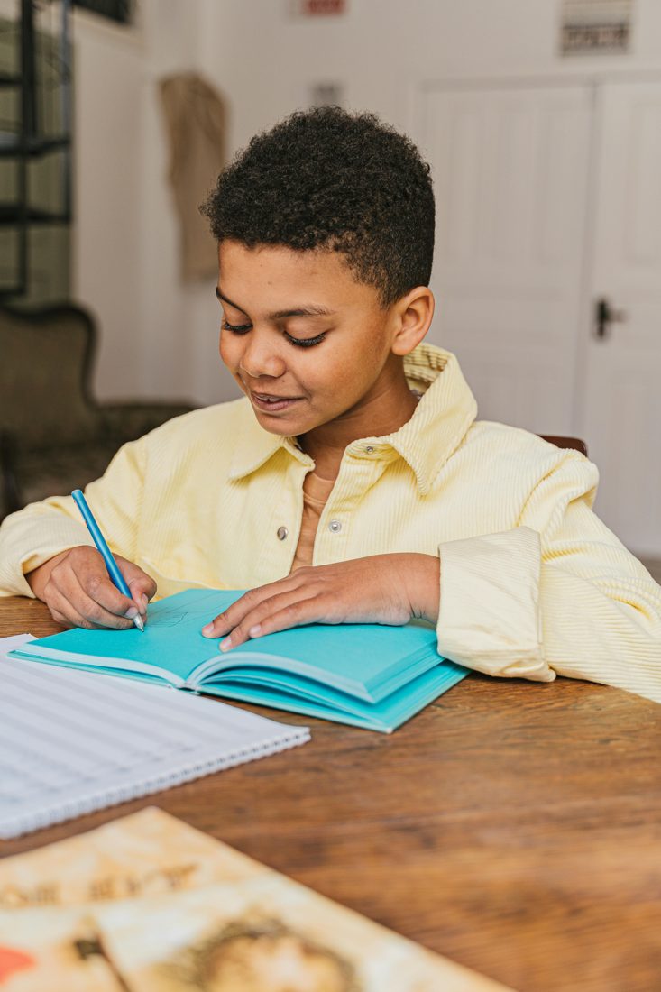A child writing and learning at a table