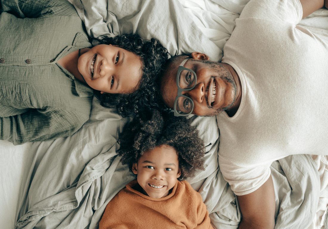 A family lying together and smiling
