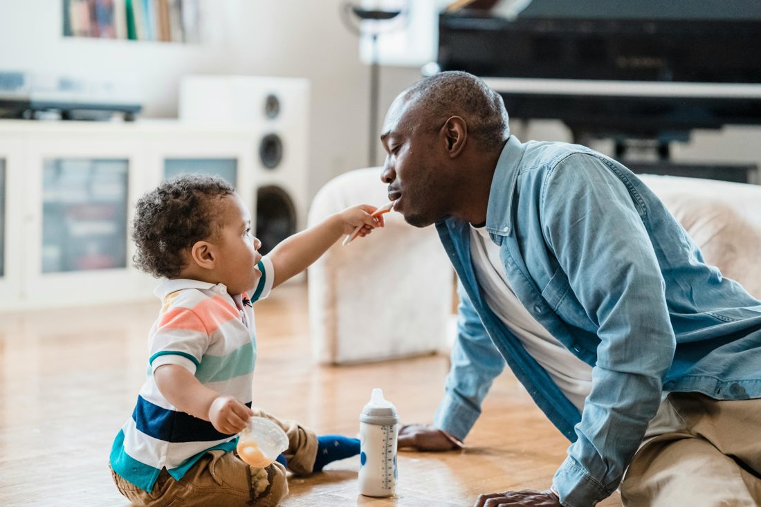 A grandparent and toddler playing together off-screen